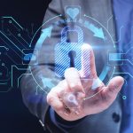 Man pointing at a glowing blue digital padlock surrounded by cybersecurity icons and circuit board patterns