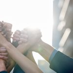 Hands of different people are being hed together